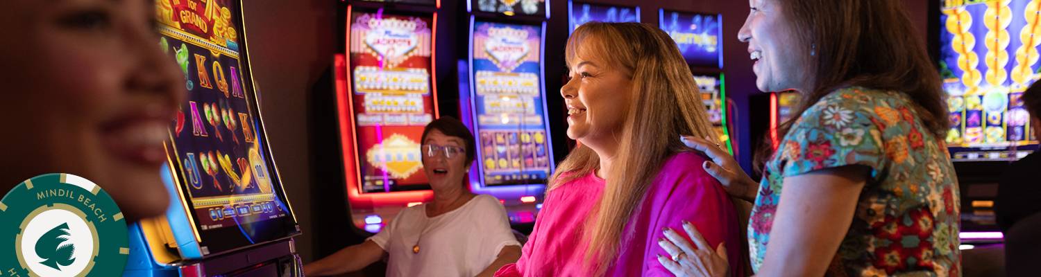 Women at slot machines laughing | Casino Gaming at Mindil Beach Casino Resort