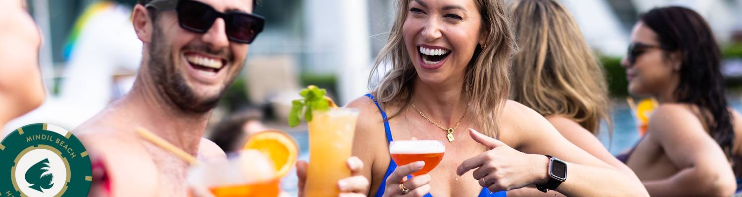 Man & Woman smiling holding drinks | Bars at Mindil Beach Casino Resort