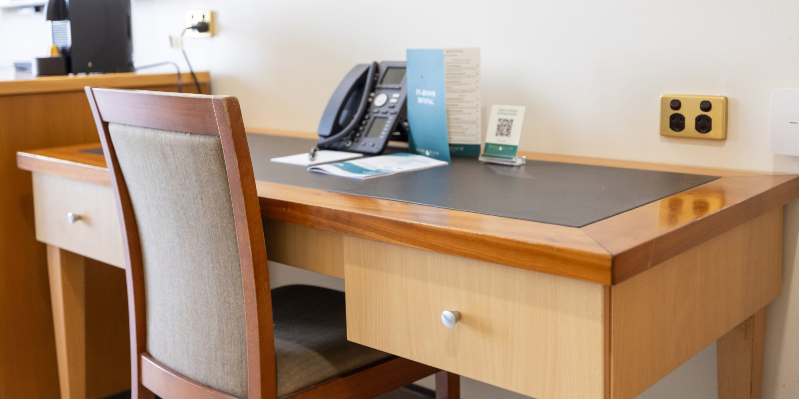 Office desk featured in hotel room.