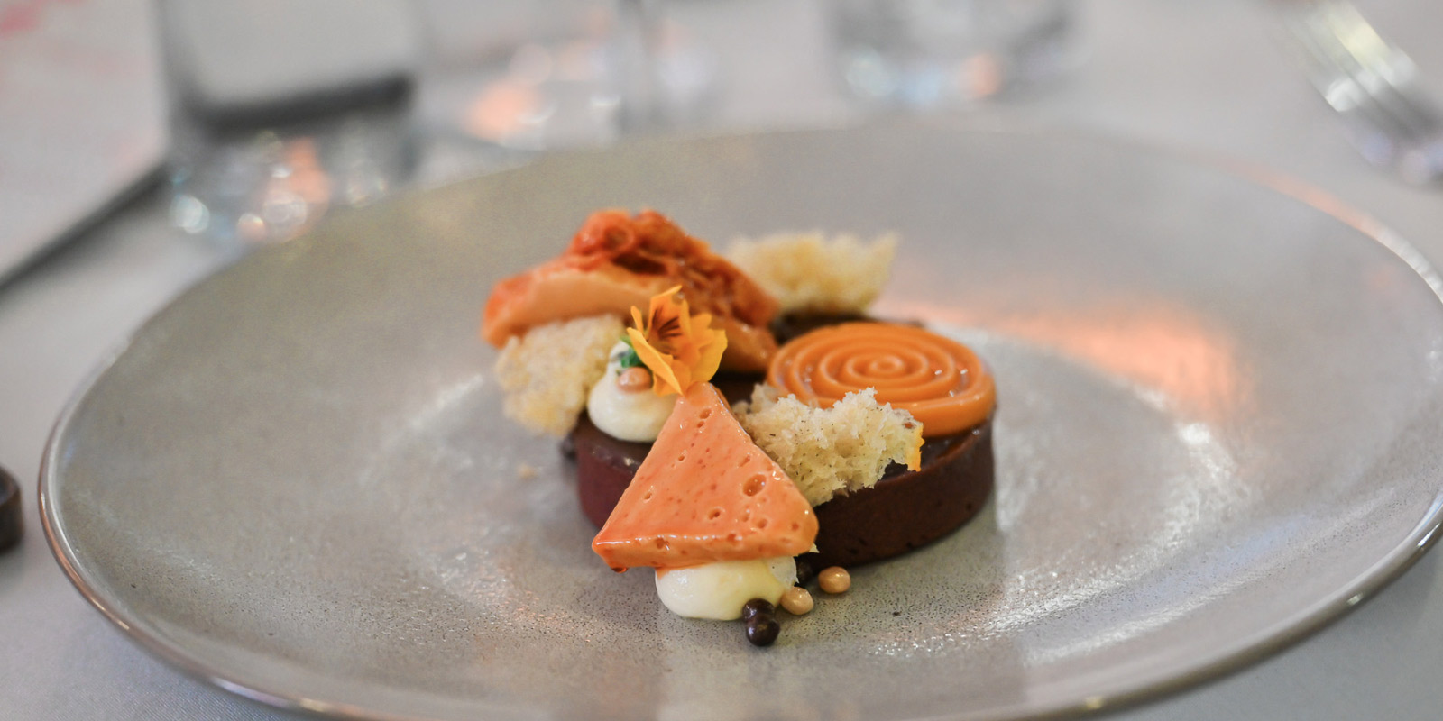 White plate serving a fine dining dessert at Mindil Beach