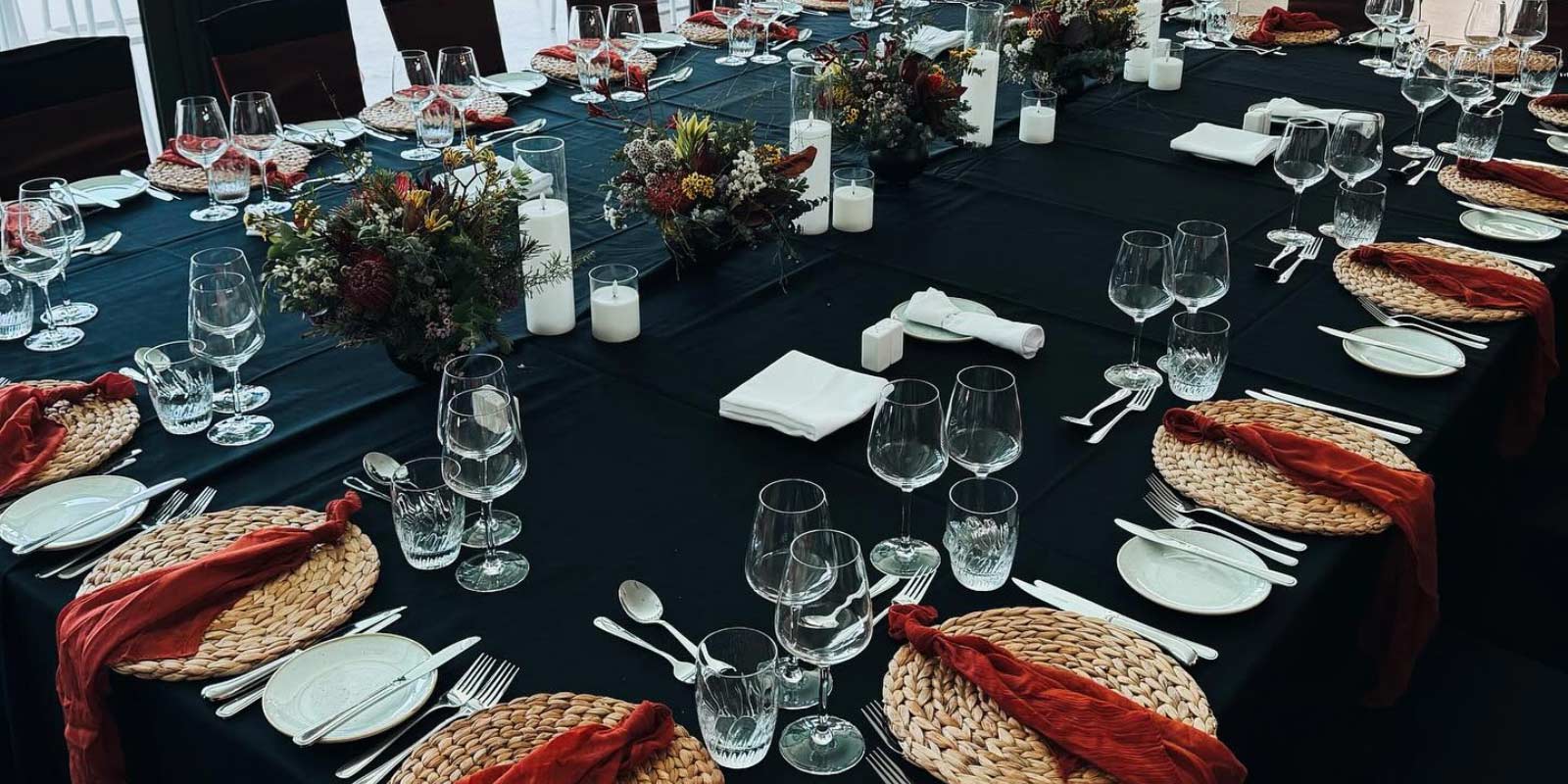 Navy table with formal place setting for a group of guests